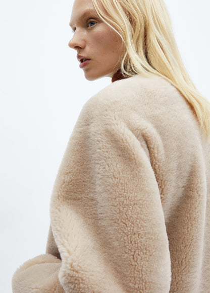 Faux fur coat with applications